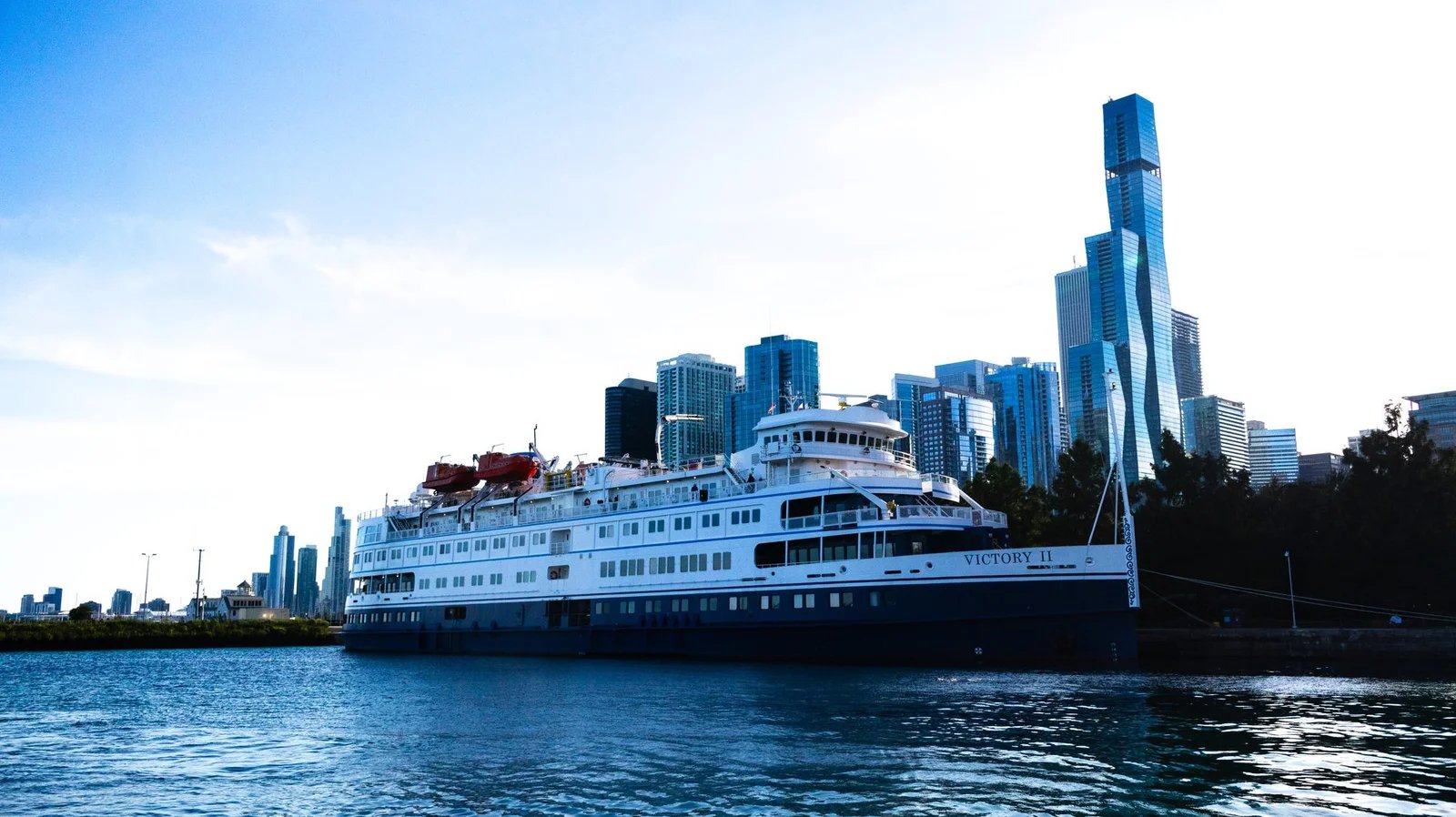 Cruise ship Victory II moored at Navy Pier with glass towers rising behind